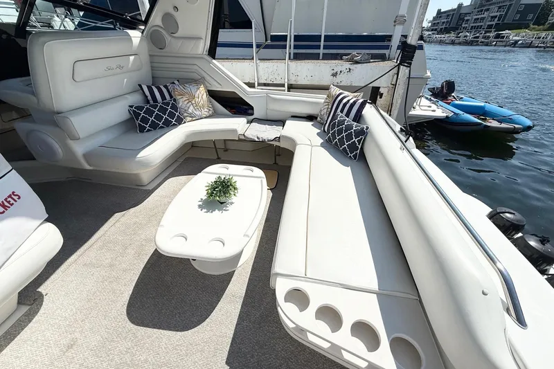 Slide: The Image of 1998 Sea Ray 400 Express Cruiser interior with plush seating and decorative pillows. - 9