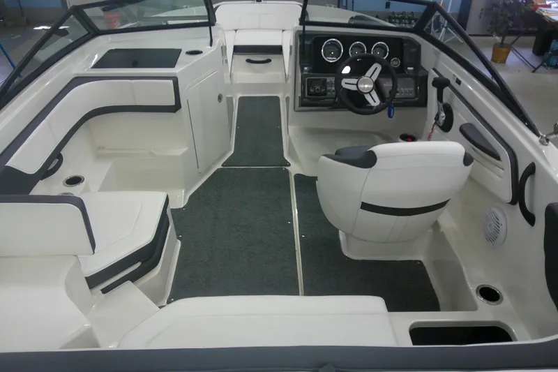 Slide: The Image of 2018 Sea Ray SPX 190 boat interior with steering wheel and seating. - 2
