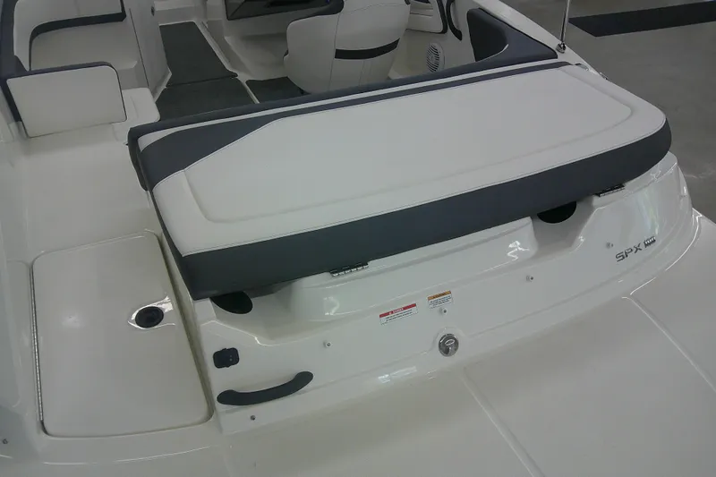 Slide: The Image of 2018 Sea Ray SPX 190 boat interior with cushioned seating and storage area. - 5