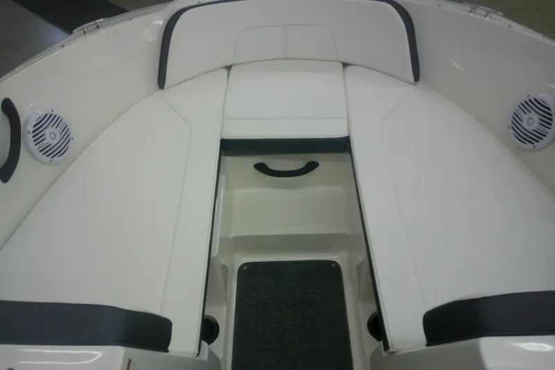 Slide: The Image of 2018 Sea Ray SPX 190 boat interior with white seating and speakers. - 8