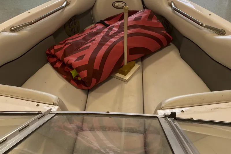 Slide: The Image of 2002 Supra Sunsport boat interior with red cover and white seating. - 10