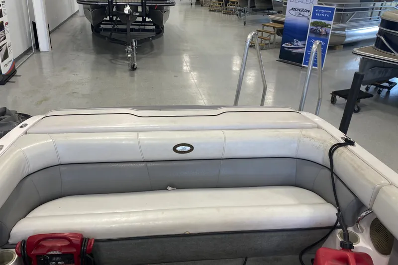 Slide: The Image of 2002 Supra Sunsport 22' boat interior with seating in showroom. - 11