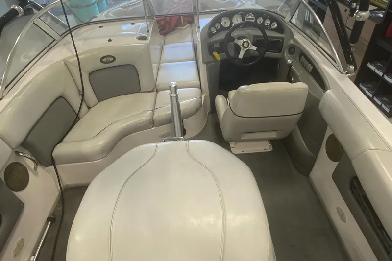 Slide: The Image of 2002 Supra Sunsport 22' boat interior with white seating and dashboard controls. - 13
