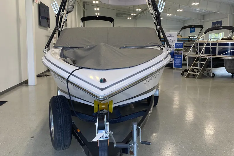 Slide: The Image of 2002 Supra Sunsport 22' boat on trailer in indoor showroom. - 3
