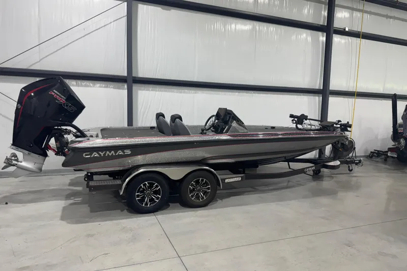 The Image of 2022 Caymas CX 21 PRO boat in a showroom, featuring sleek design and powerful engine. - 1
