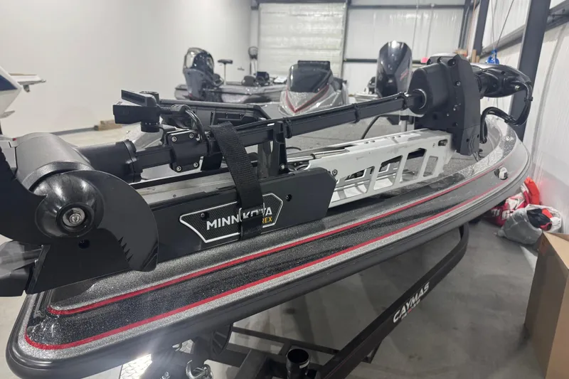 Slide: The Image of 2022 Caymas CX 21 PRO boat with Minn Kota trolling motor in a showroom. - 5