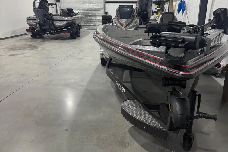 Slide: The Image of 2022 Caymas CX 21 PRO bass boats in a garage, showcasing sleek design and advanced features. - 7