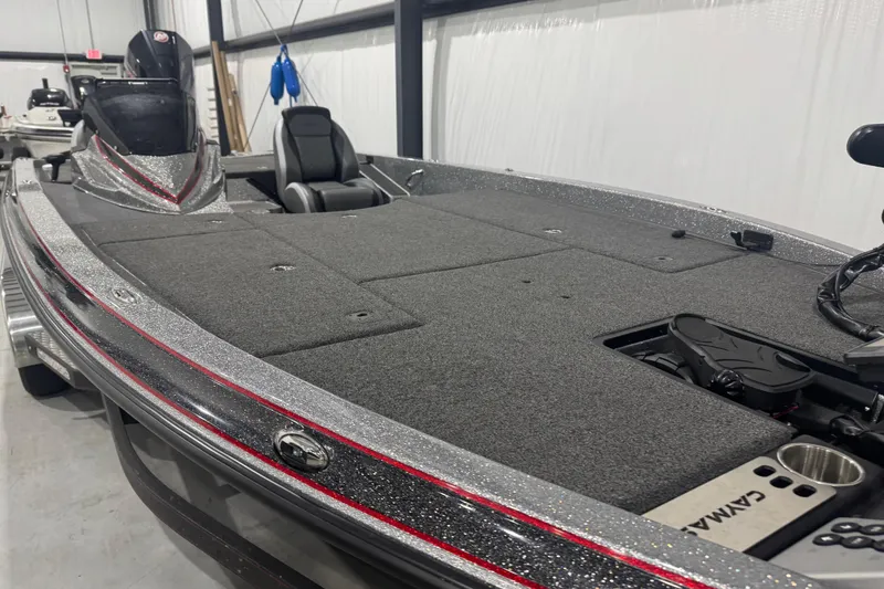 Slide: The Image of 2022 Caymas CX 21 PRO bass boat with spacious deck and sleek design in a showroom. - 8