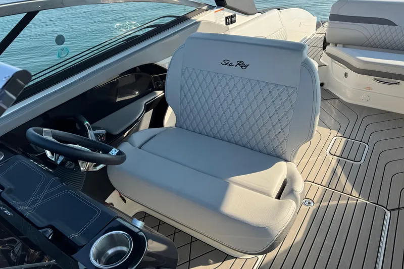 Slide: The Image of 2024 Sea Ray SLX 280 boat interior with luxurious seating and steering wheel. - 10