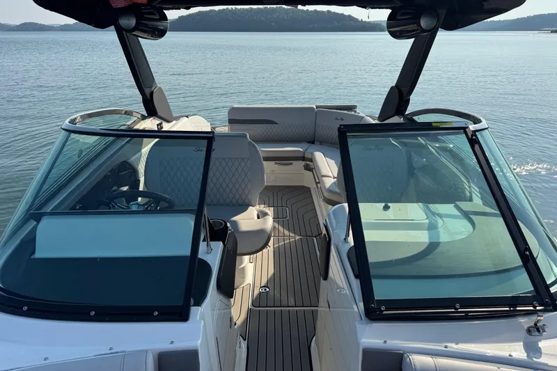 Slide: The Image of 2024 Sea Ray SLX 280 boat interior with luxurious seating and sleek design on calm water. - 12