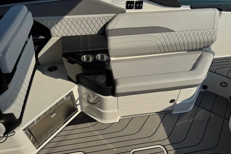 Slide: The Image of 2024 Sea Ray SLX 280 boat interior with luxurious seating and cup holders. - 14