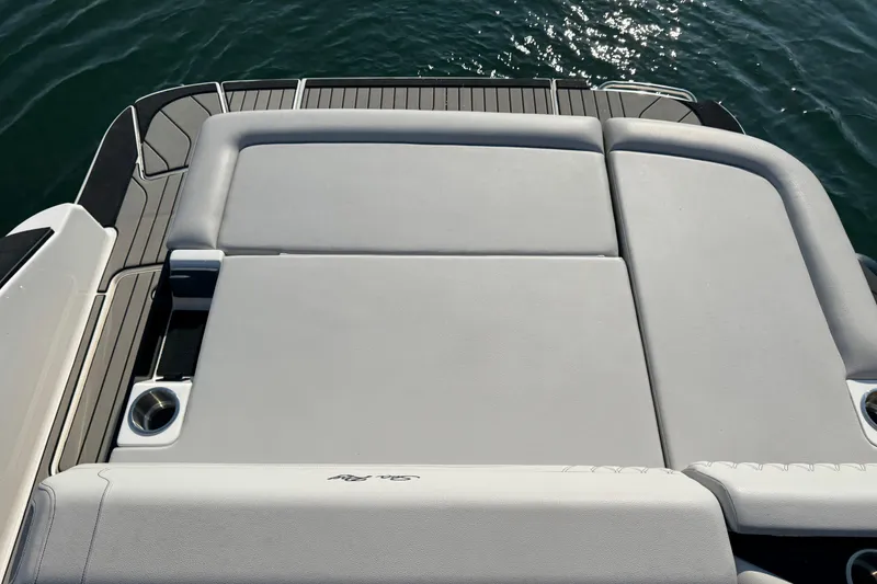 Slide: The Image of 2024 Sea Ray SLX 280 boat with spacious sunpad and cup holders on deck. - 17