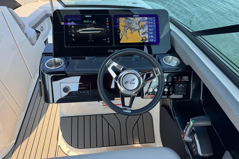 Slide: The Image of 2024 Sea Ray SLX 280 helm with dual Simrad displays and modern controls. - 6