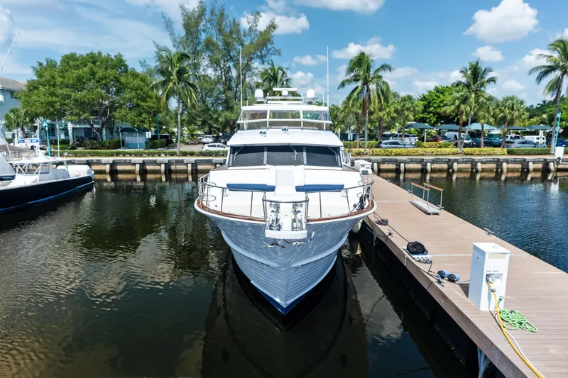 Slide: The Image of 2005 Grand Banks 72 Aleutian RP yacht docked at marina with palm trees. - 17