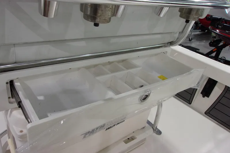 Slide: The Image of 2024 Pathfinder 2200 boat storage compartment with organized sections and stainless steel fixtures. - 15