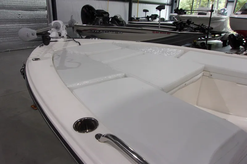 Slide: The Image of 2024 Pathfinder 2200 boat interior with cushioned seating and fishing equipment. - 18