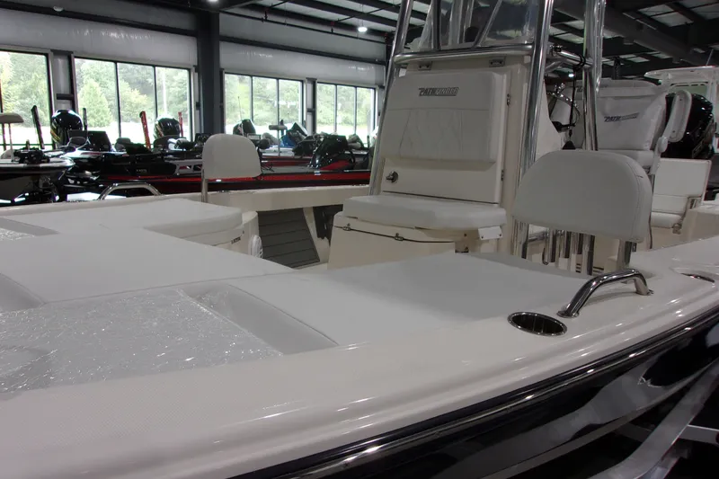 Slide: The Image of 2024 Pathfinder 2200 boat interior with seating and console in showroom. - 19