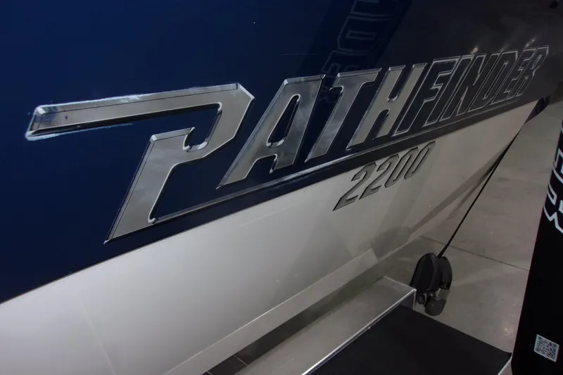 Slide: The Image of 2024 Pathfinder 2200 boat logo on blue and white hull. - 23