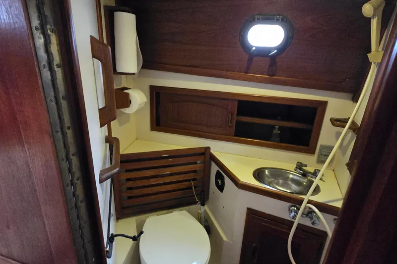 Slide: The Image of Compact bathroom in a 1985 Pacific Seacraft 37 sailboat, featuring a sink and toilet. - 10
