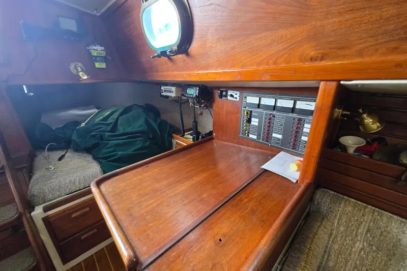 Slide: The Image of Interior of 1985 Pacific Seacraft 37 sailboat with wooden desk and control panel. - 12