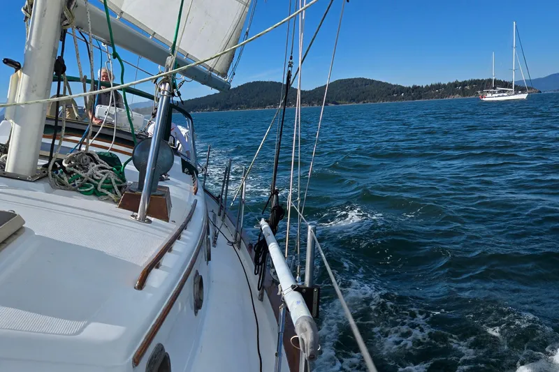 Slide: The Image of Sailing on a 1985 Pacific Seacraft 37 yacht in clear blue waters. - 16