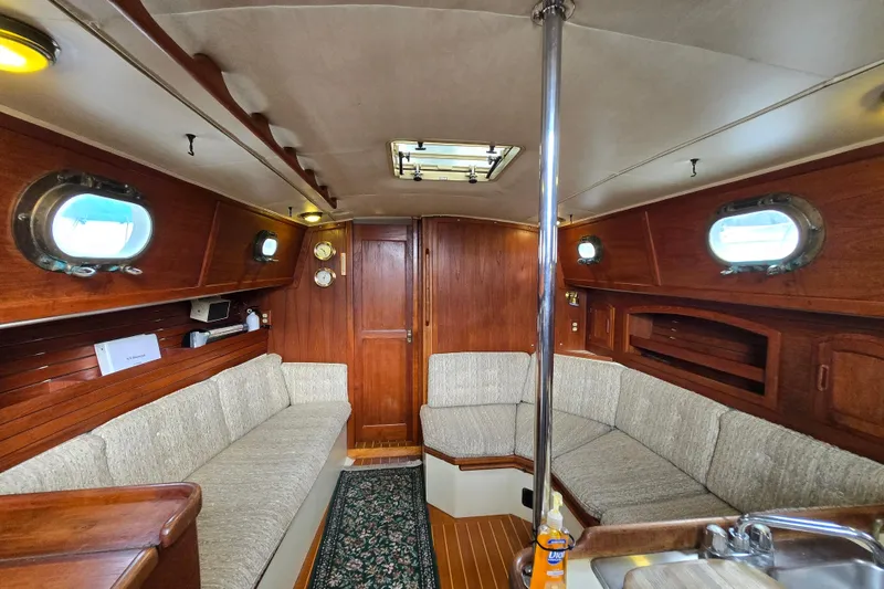 Slide: The Image of Interior of 1985 Pacific Seacraft 37 sailboat with wooden finish and cozy seating area. - 3