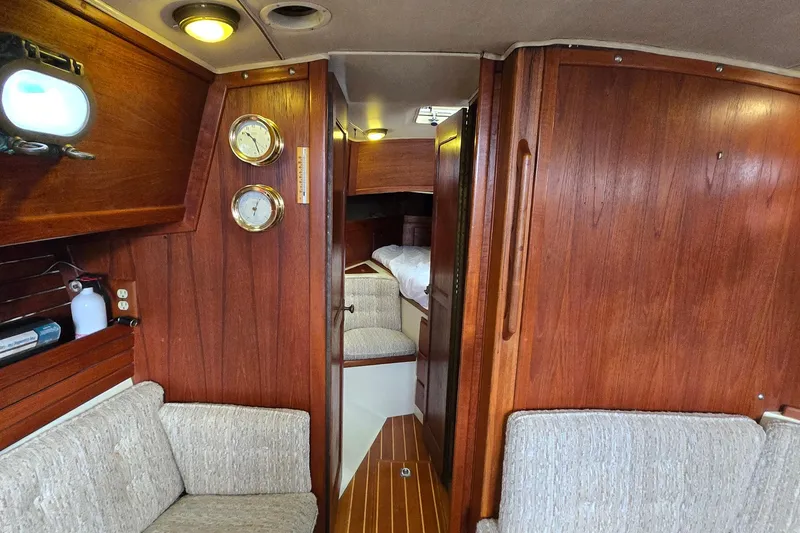 Slide: The Image of Interior of 1985 Pacific Seacraft 37 sailboat with wooden paneling and cozy seating. - 4