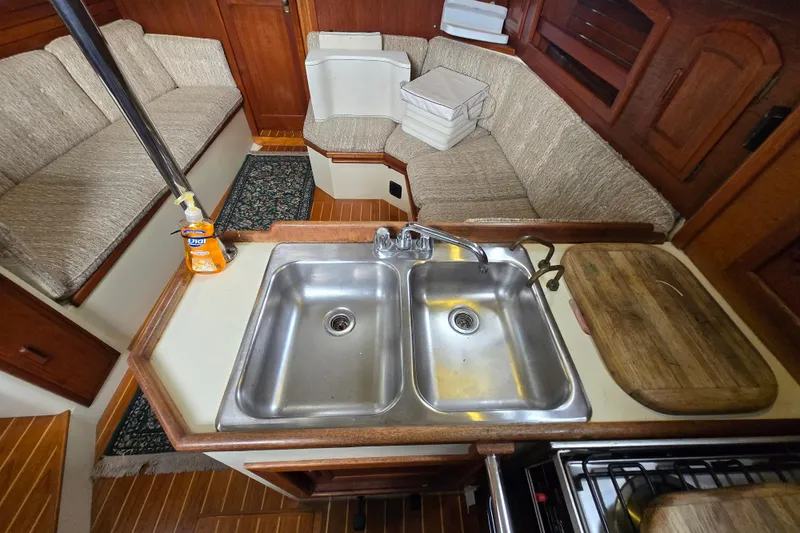 Slide: The Image of Interior of 1985 Pacific Seacraft 37 sailboat with kitchen sink and seating area. - 8