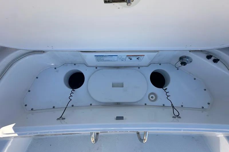 Slide: The Image of 2023 Yamaha Boats 252 FSH Sport storage compartment with cup holders and utility features. - 10