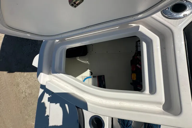 Slide: The Image of Storage compartment of 2023 Yamaha Boats 252 FSH Sport, open and empty. - 13