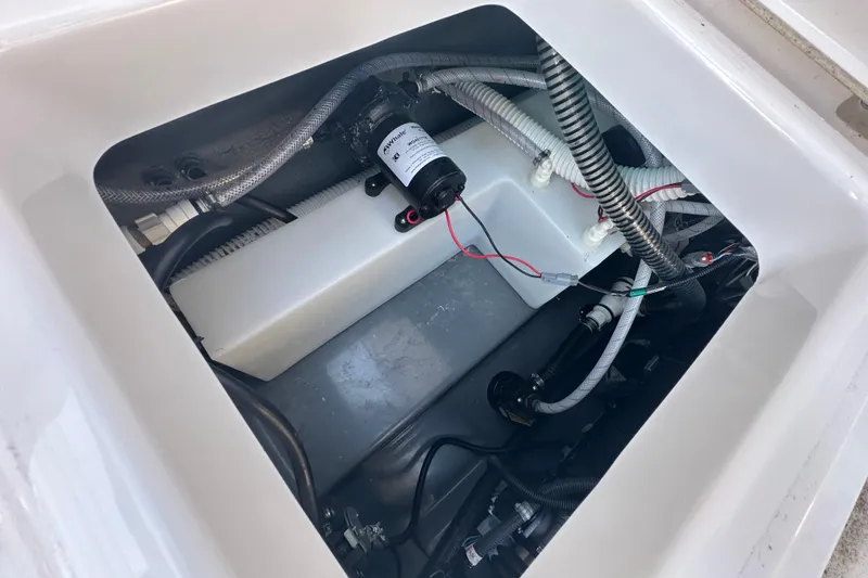 Slide: The Image of 2023 Yamaha Boats 252 FSH Sport engine compartment with wiring and components. - 15