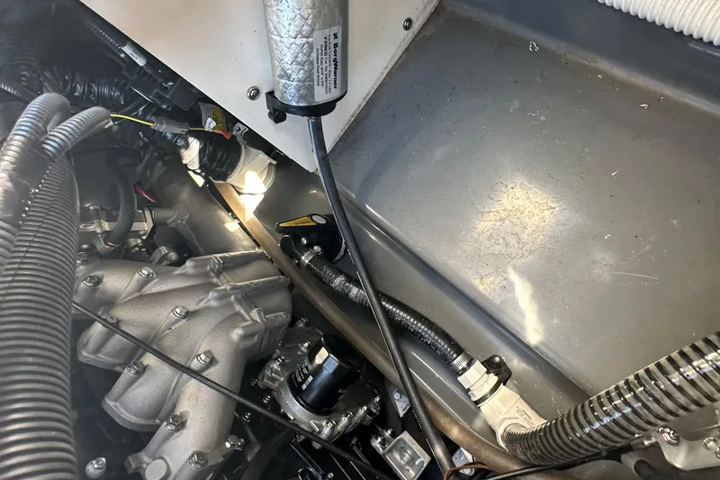 Slide: The Image of Engine compartment of 2023 Yamaha Boats 252 FSH Sport, showcasing mechanical components and wiring. - 16