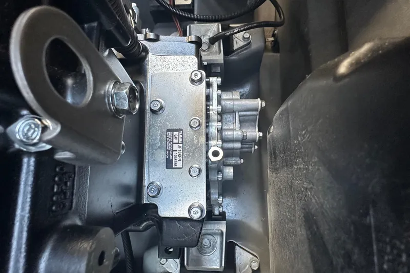 Slide: The Image of Close-up of 2023 Yamaha Boats 252 FSH Sport engine component, showcasing intricate mechanical details. - 19