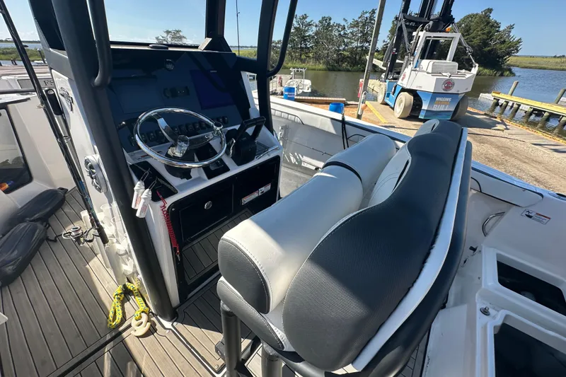 Slide: The Image of 2023 Yamaha Boats 252 FSH Sport interior with steering wheel and seating. - 21