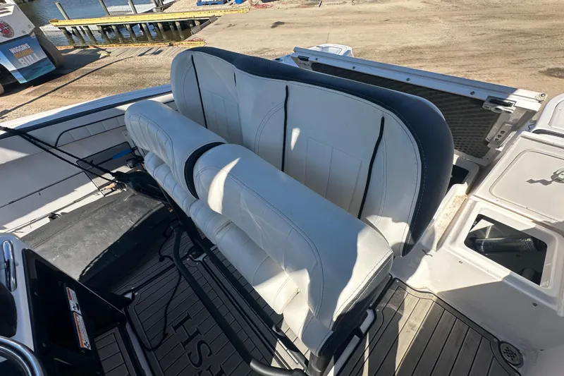 Slide: The Image of 2023 Yamaha Boats 252 FSH Sport interior with white seating and deck view. - 22