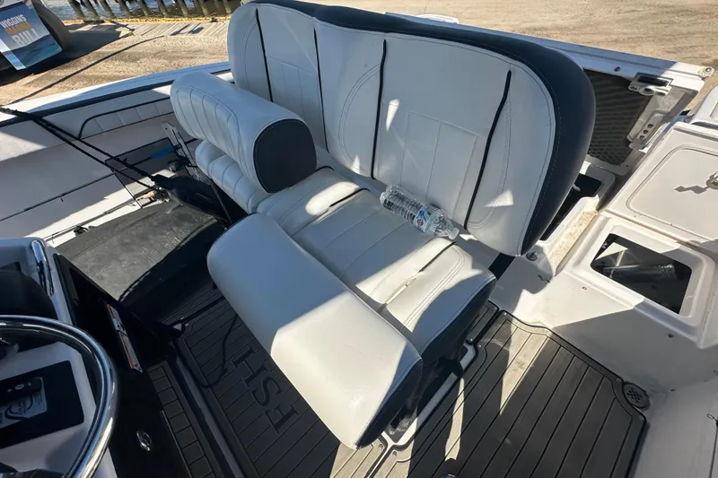 Slide: The Image of 2023 Yamaha Boats 252 FSH Sport interior with white seating and steering wheel. - 23