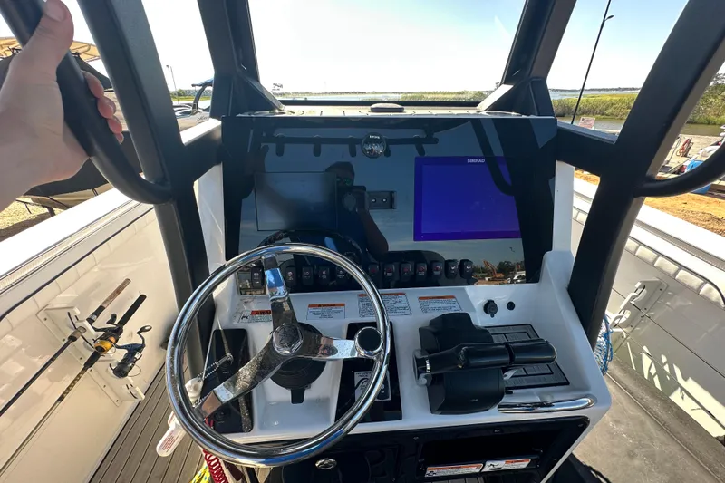 Slide: The Image of 2023 Yamaha Boats 252 FSH Sport dashboard with steering wheel and controls. - 25