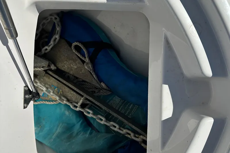 Slide: The Image of Storage compartment of 2023 Yamaha Boats 252 FSH Sport with anchor and chain. - 29