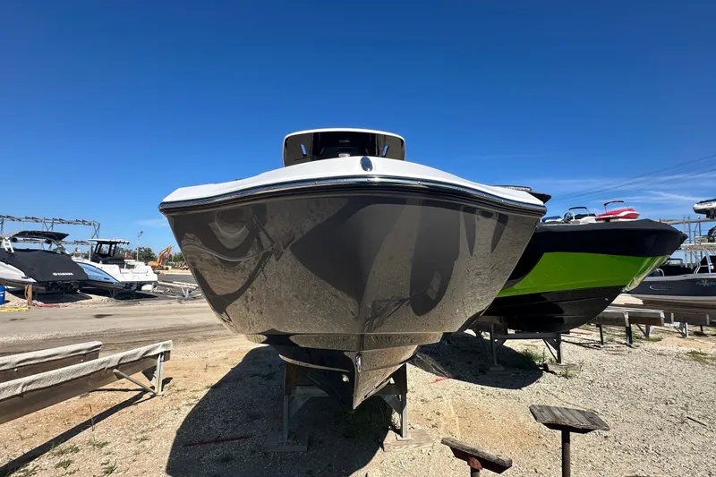 Slide: The Image of 2023 Yamaha Boats 252 FSH Sport on display, front view under clear blue sky. - 3