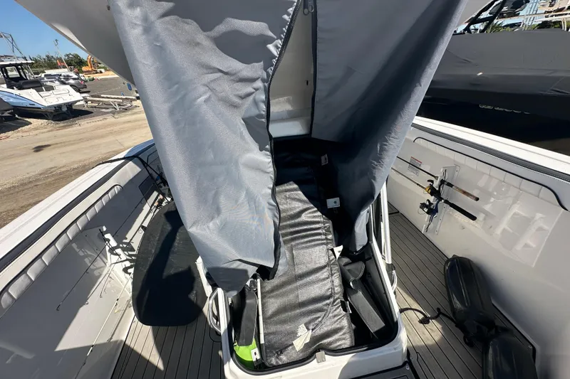 Slide: The Image of 2023 Yamaha Boats 252 FSH Sport interior with protective cover partially open. - 34