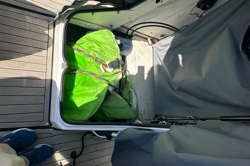 Slide: The Image of Storage compartment of 2023 Yamaha Boats 252 FSH Sport with green equipment inside. - 35