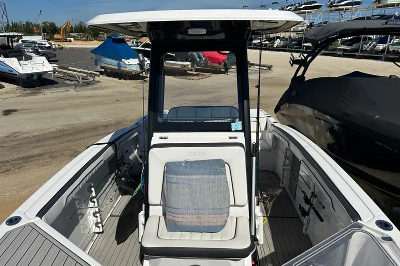 Slide: The Image of 2023 Yamaha Boats 252 FSH Sport interior view at a marina. - 37