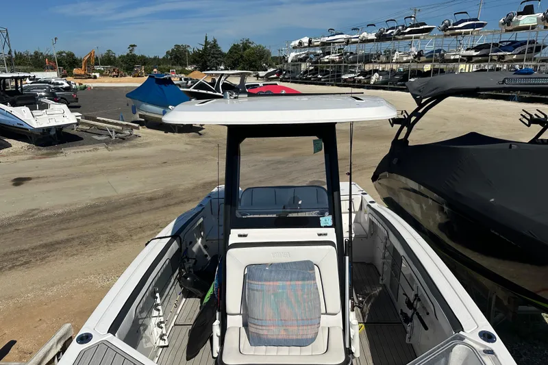 Slide: The Image of 2023 Yamaha Boats 252 FSH Sport in a marina, surrounded by other boats. - 39