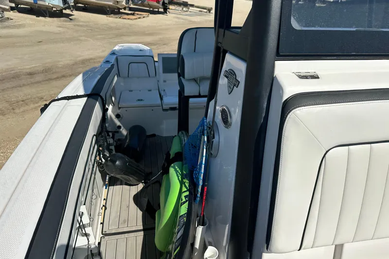 Slide: The Image of 2023 Yamaha Boats 252 FSH Sport interior with fishing gear and seating. - 40