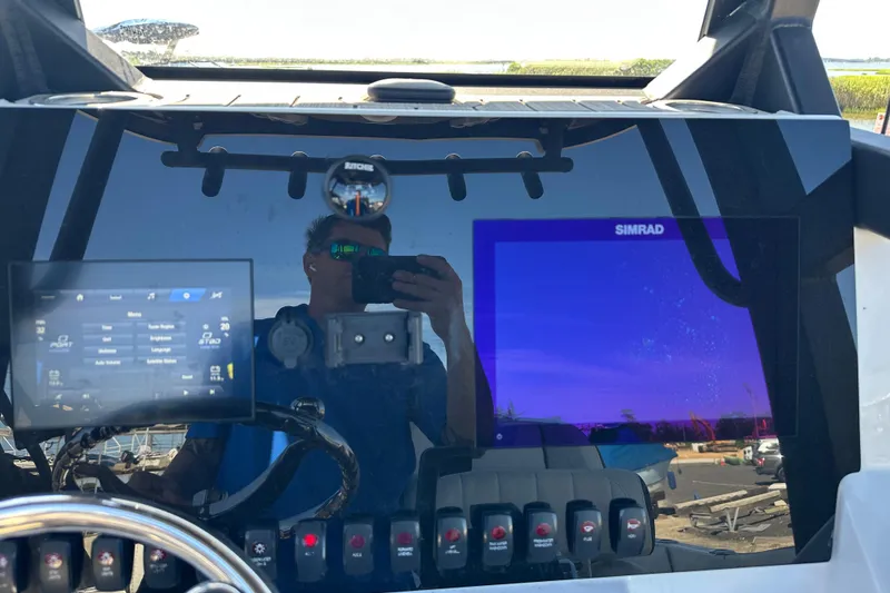 Slide: The Image of 2023 Yamaha Boats 252 FSH Sport dashboard with Simrad display and control panel. - 46