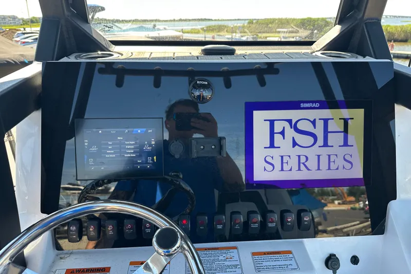 Slide: The Image of 2023 Yamaha Boats 252 FSH Sport dashboard with controls and FSH Series display. - 48
