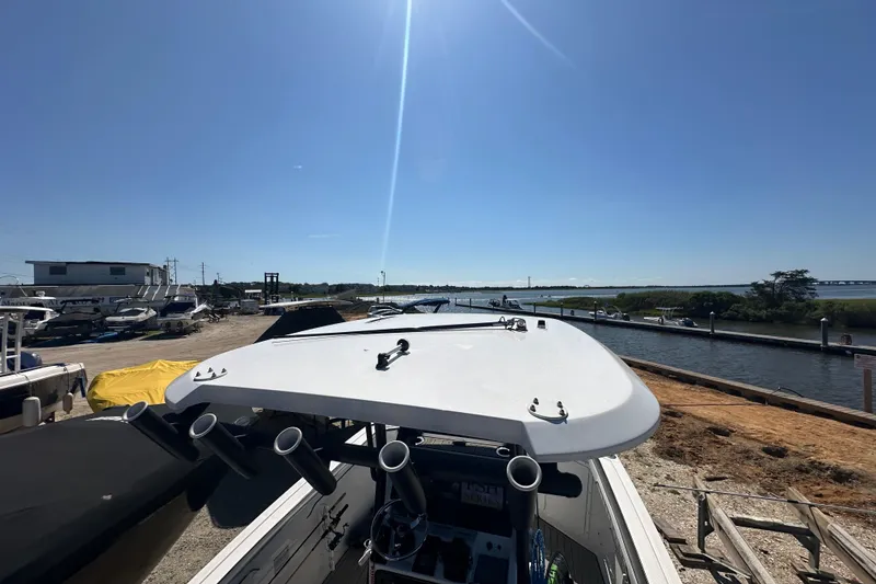 Slide: The Image of 2023 Yamaha Boats 252 FSH Sport docked under clear blue sky. - 51