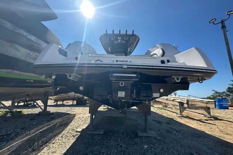 Slide: The Image of 2023 Yamaha Boats 252 FSH Sport under bright sun, displayed on a stand. - 8