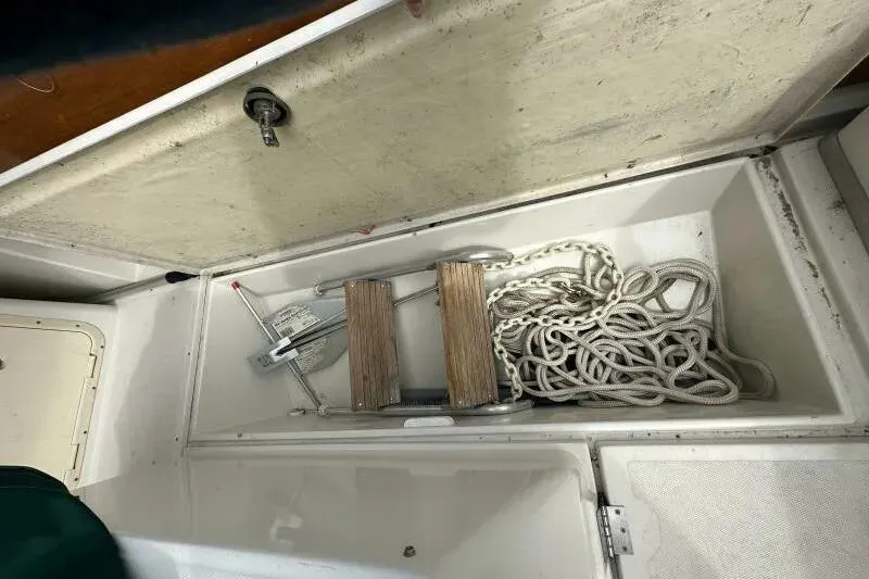 Slide: The Image of Open storage compartment on 1997 Limestone 24 Cuddy boat with anchor and rope. - 14