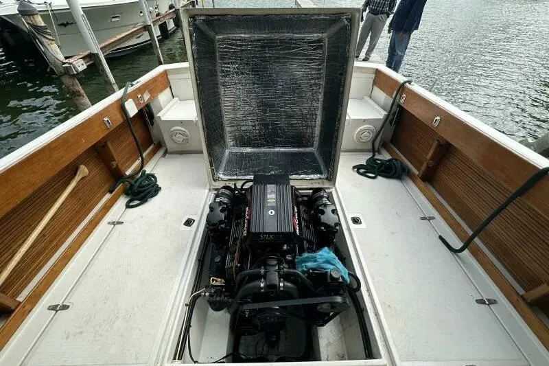 Slide: The Image of 1997 Limestone 24 Cuddy boat engine compartment with open hatch, dockside view. - 15